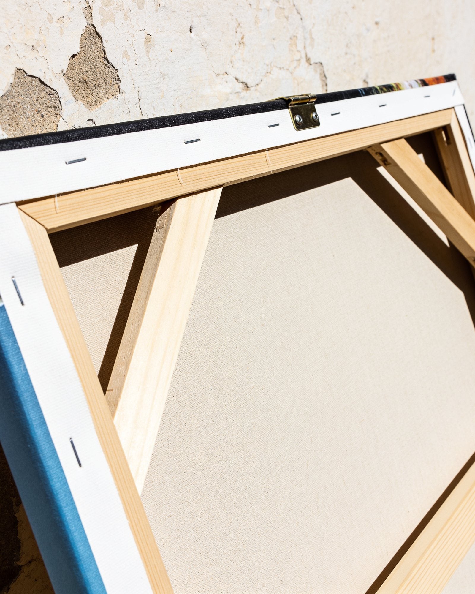 The back of a canvas, stretched over solid wood bars with the hanging bracket fitted.